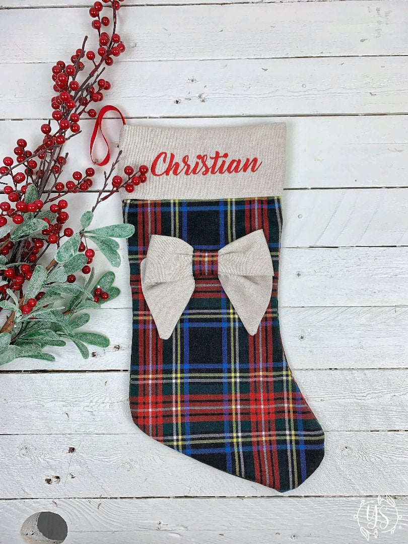 Calza natalizia in tartan con risvolto ecrù con fiocco nella parte centrale